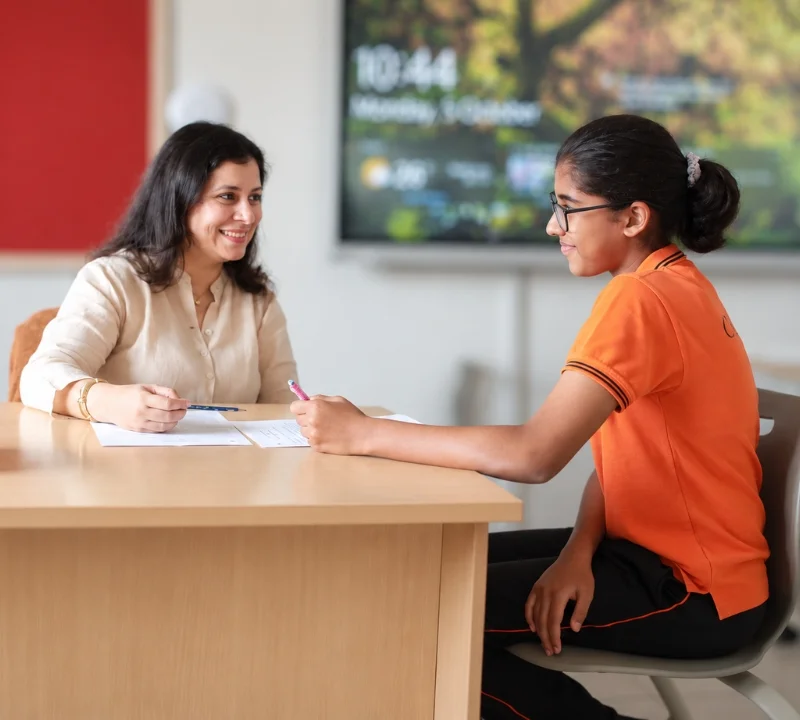Teacher conferencing with an IGCSE student